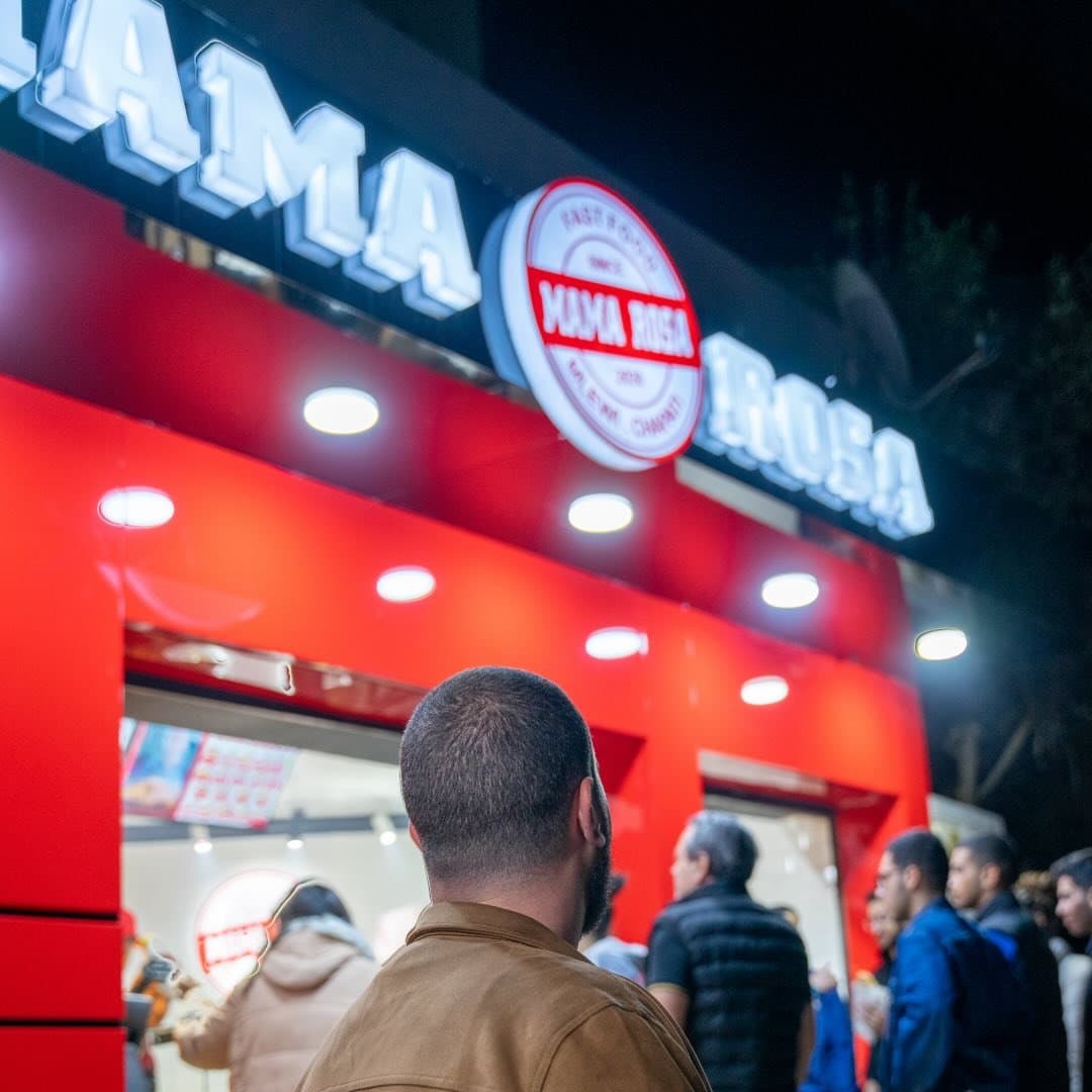 Mama Rosa storefront with vibrant red branding and bustling atmosphere