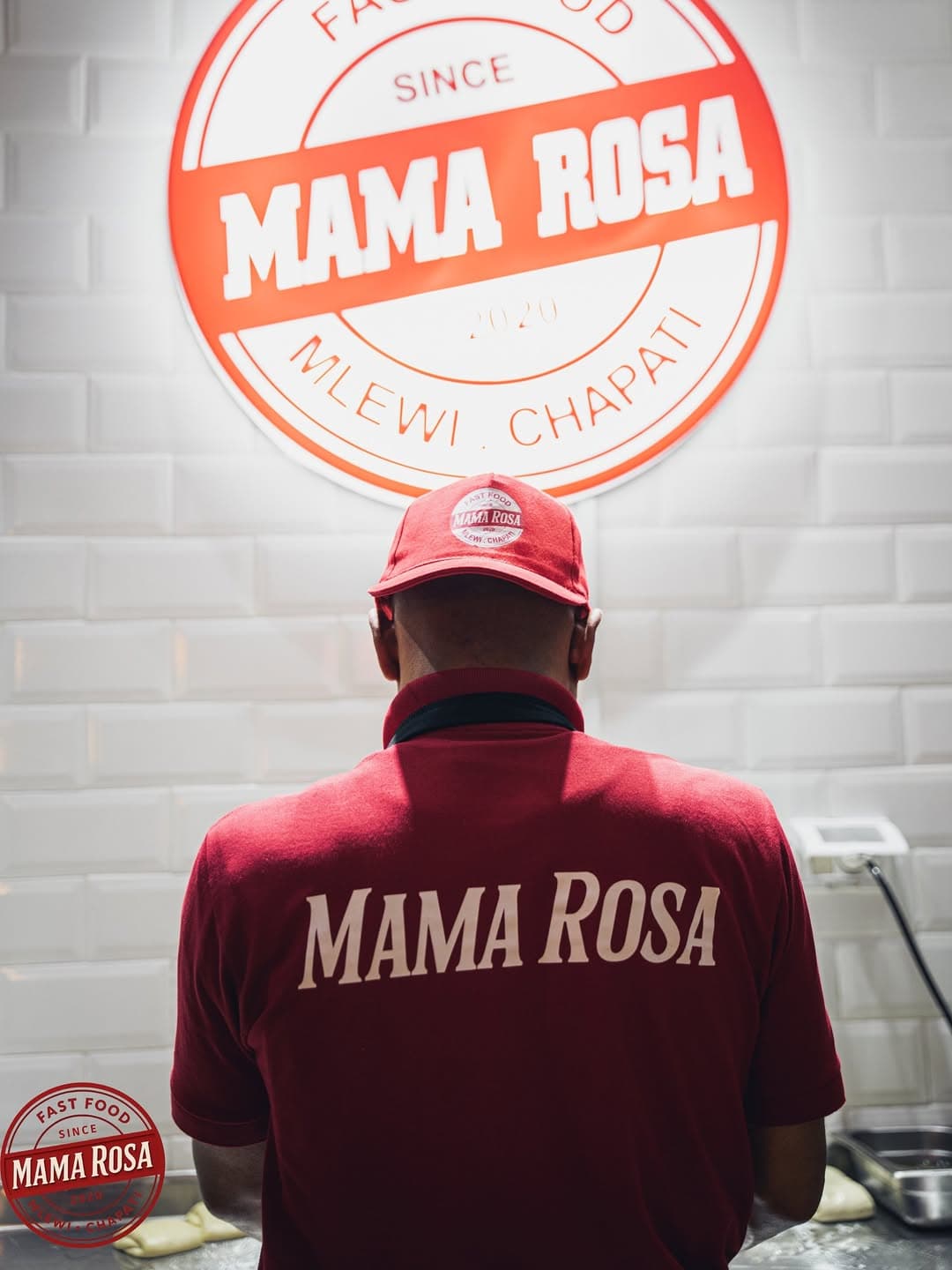 Chef in Mama Rosa uniform preparing food in the kitchen