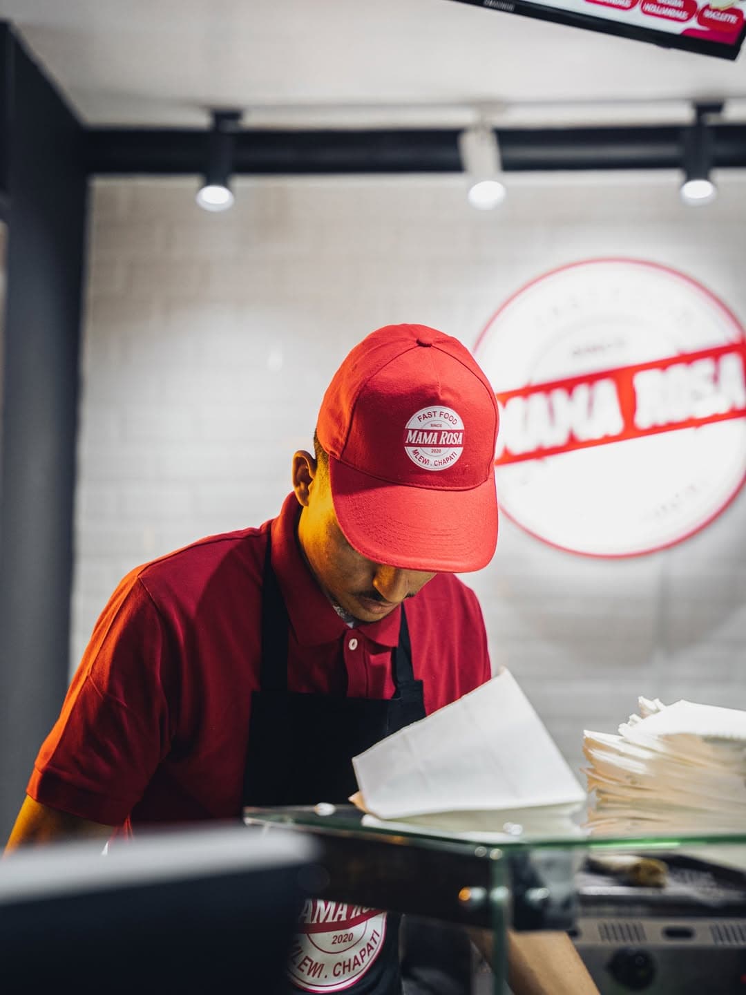 Kitchen staff member focused on food preparation